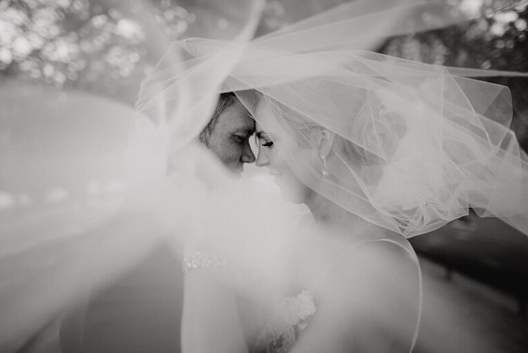 a couple seen through the brides veil